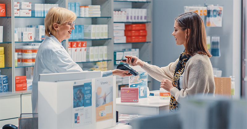 Woman getting prescription filled at pharmacy