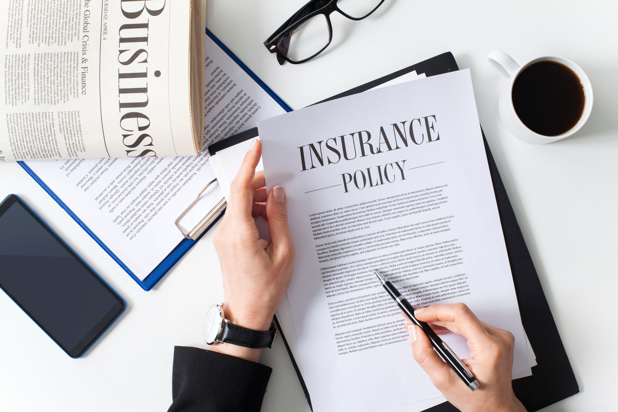 Business woman showing insurance document over white desk at office