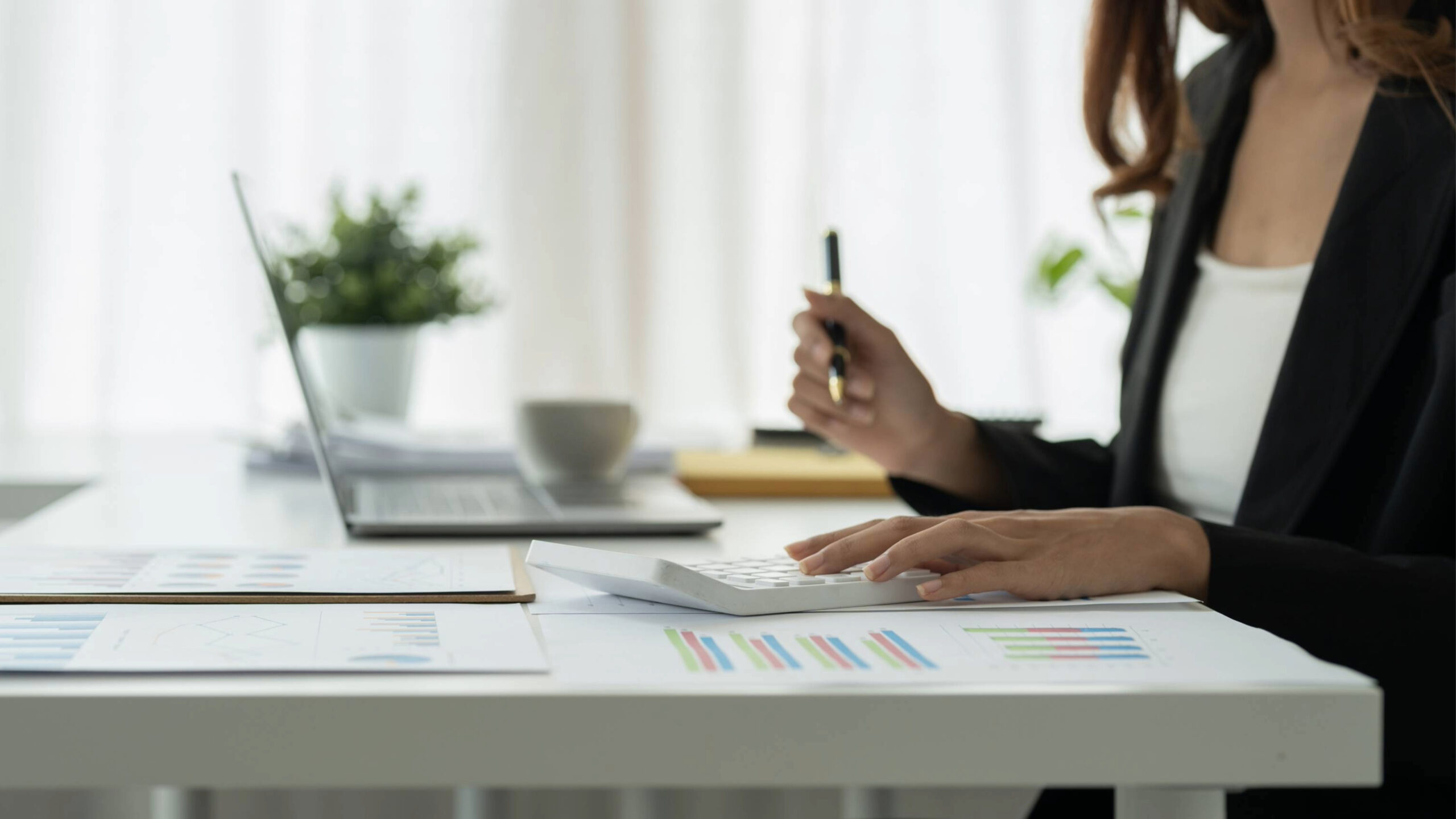Woman at a computer doing paperwork