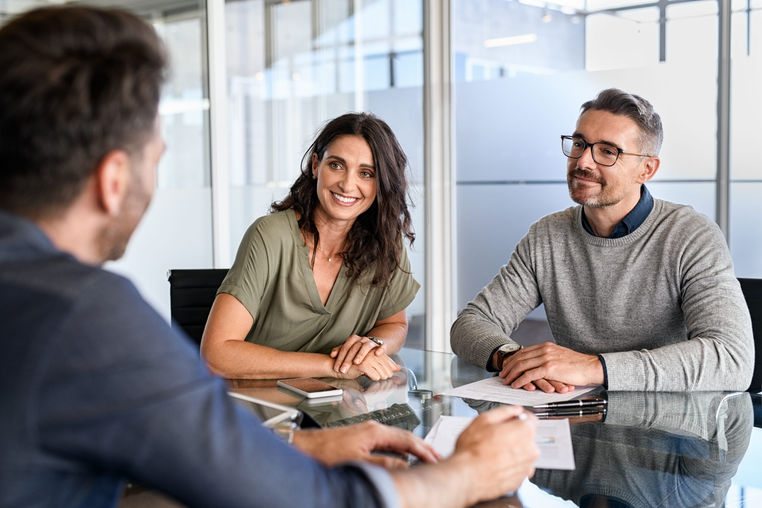 Couple speaking with a financial advisor