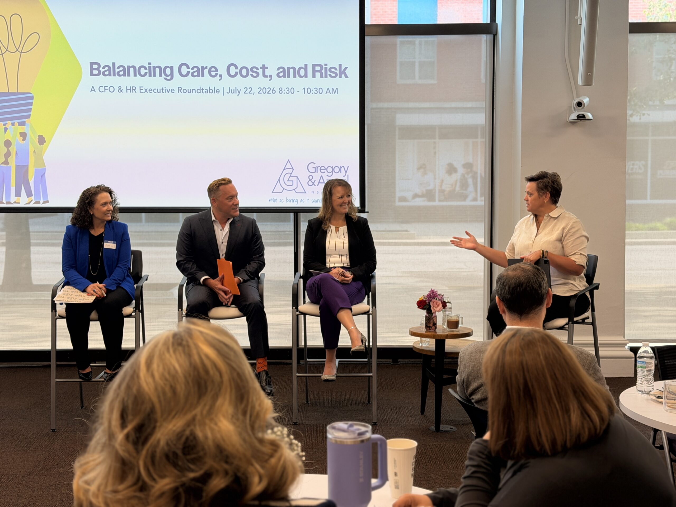 A picture of four executives speaking at a panel discussion
